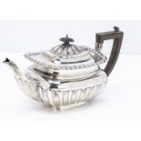An Edwardian silver teapot, 20.8 oz., with applied black handle and finial