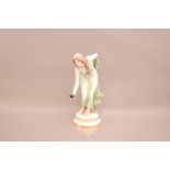 An early 20th century Meissen porcelain figure of a lady playing bowls designed by Walter Schott,