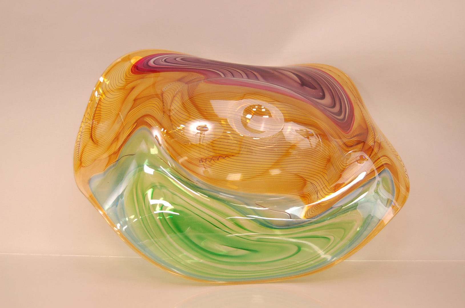 A large Studio Glass Contour Range centrepiece bowl by Bob Crooks, 69cm wide, in amber with greens - Image 2 of 3