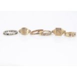 A quantity of 9ct rings, including two gem set signet rings, a diamond dress ring, and three others,