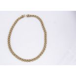 A 9ct gold flattened link three section necklace, having box and tongue clasp with safety clasp,