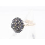 A sapphire cluster ring, of cone design, with basket mount and gallery on yellow metal shank, ring