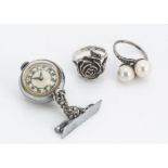 A lady's Art Deco white metal and chrome fob watch brooch, together with two silver dress rings