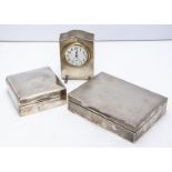 Two George V silver cigarette boxes and a desk clock, largest box 14cm, clock with key and running