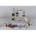 A large collection of table lighters, including a silver cased example, together with a selection of