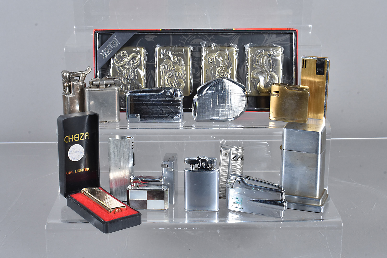 A Zippo Barcroft table lighter, together with four Zippo style pocket lighters in original
