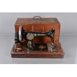 A vintage hand-operated Pfaff sewing machine, serial 894099, in case