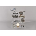An assortment of figural table lighters, including a locomotive, a fighter jet, a tank, a vintage