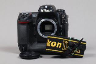 A Nikon D2H DSLR Camera body, serial no 2011756, body G, scratches to base, with body cap, strap,