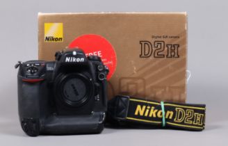 A Nikon D2H DSLR Camera body, serial no 2036285, body G, some wear, with body cap, display screen
