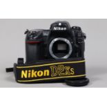 A Nikon D2Xs DSLR Camera Body, serial no 6025865, body G, some wear, with body cap, strap, battery