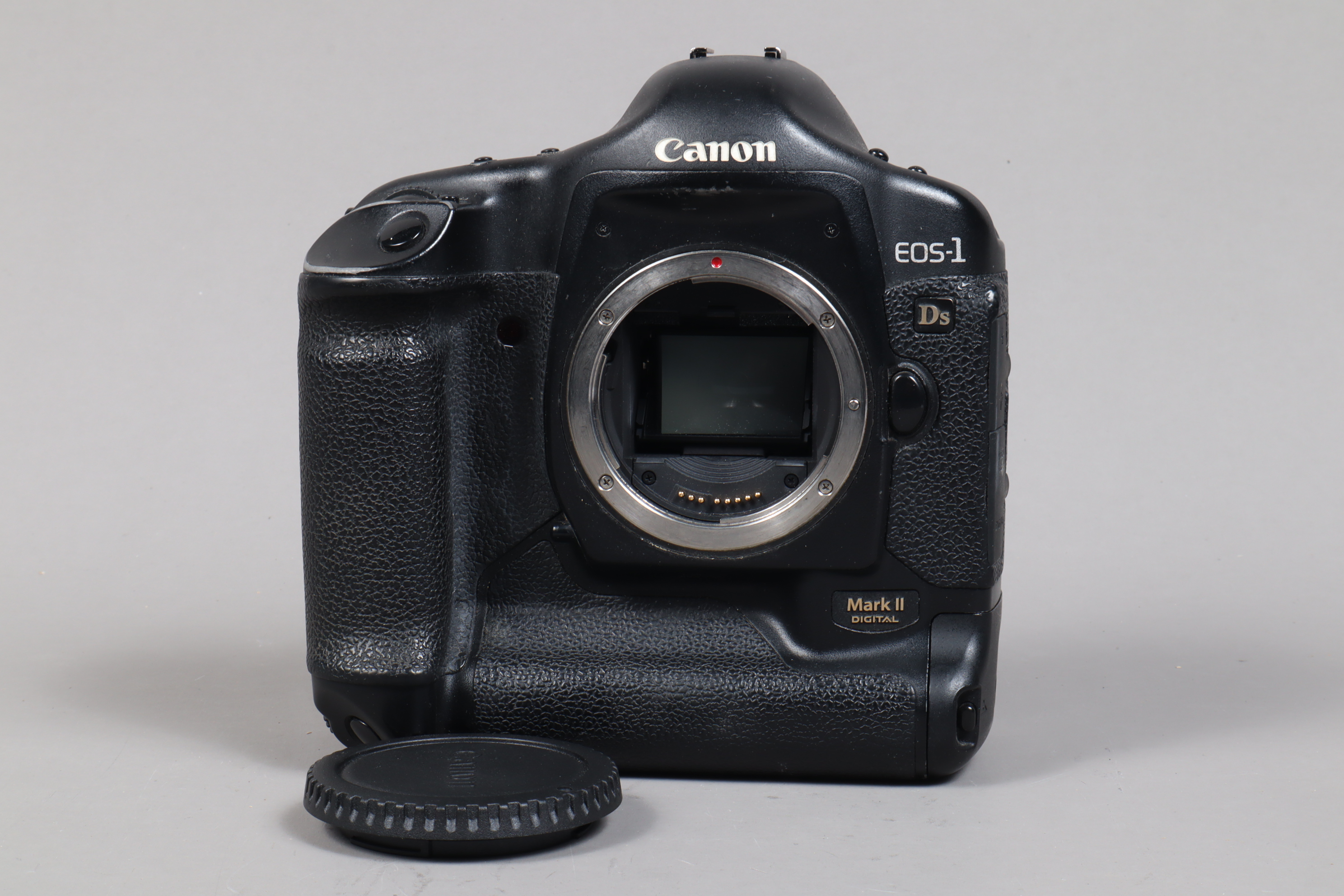 A Canon EOS-1 Ds Mark II DSLR Camera Body, serial no 319701, body G, some wear to edges, with body