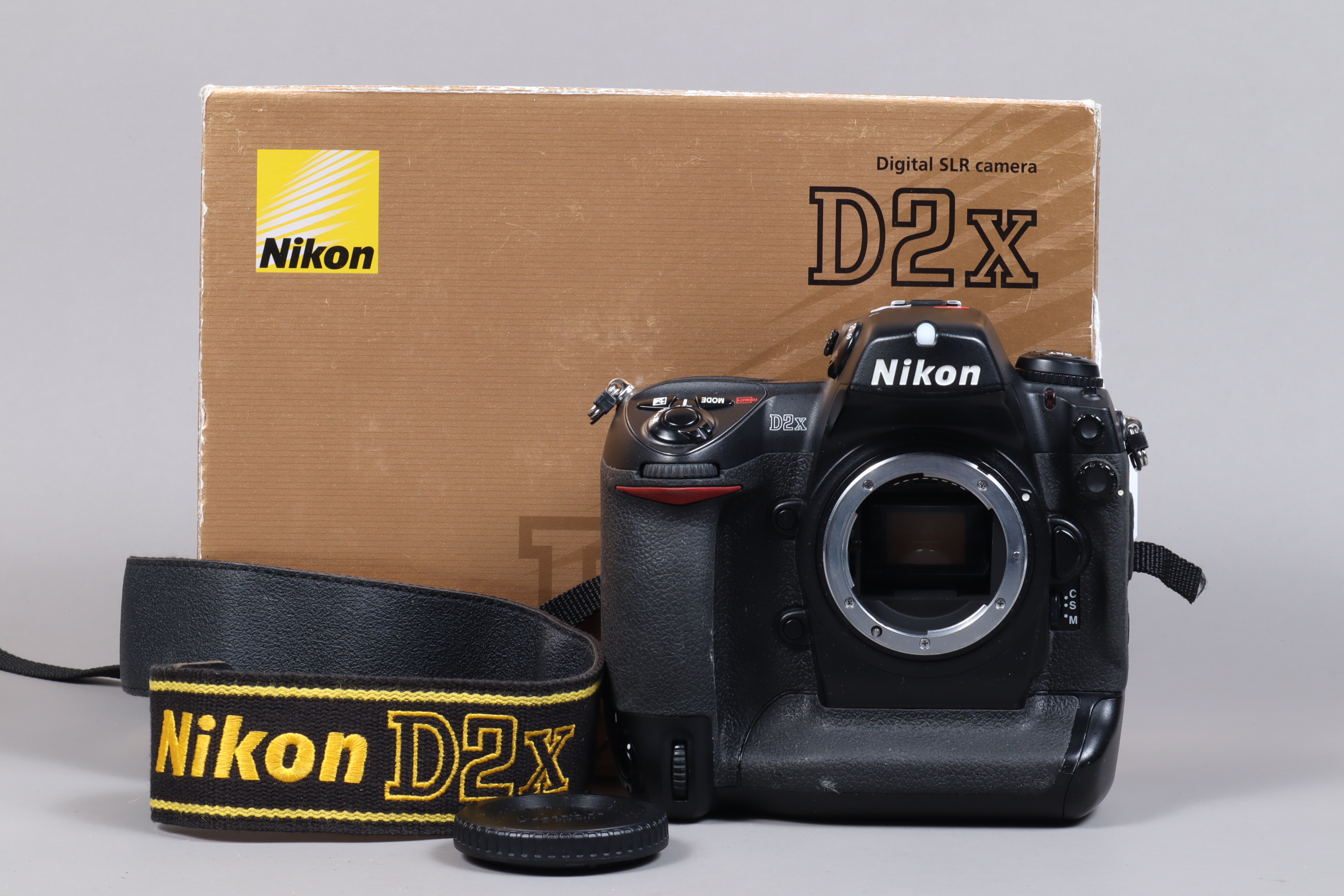 A Nikon D2x DSLR Camera Body, serial no 5014157, body G, light wear, with body cap, strap, manual,