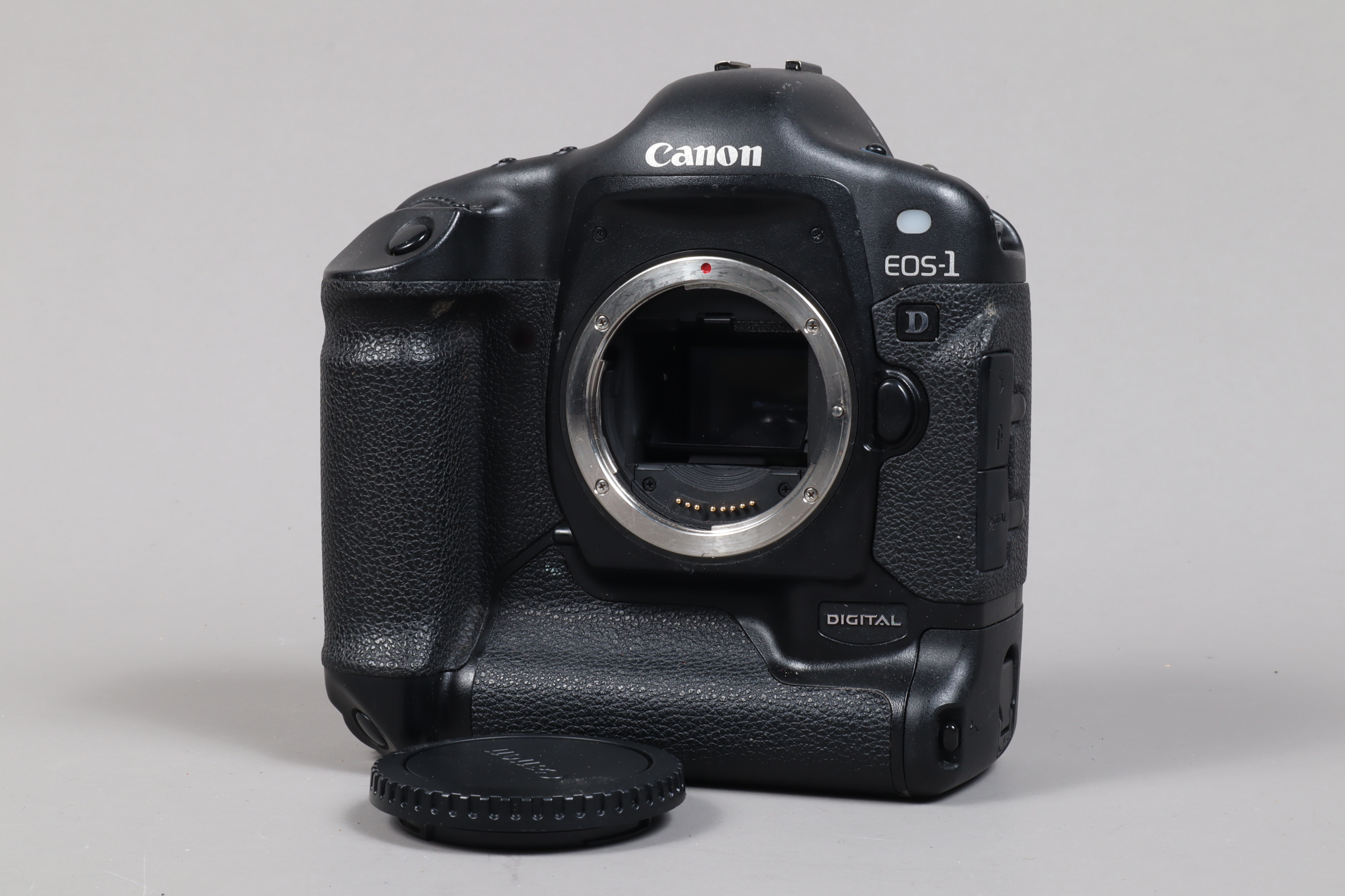 A Canon EOS-1 D DSLR Camera Body, serial no 009787, body G, light wear, with body cap, battery and