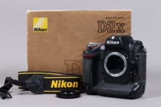 A Nikon D2x DSLR Camera Body, serial no 5040382, body G, some wear, with body cap, strap, cables,