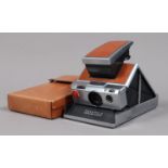 A Polaroid Six-70 Land Camera, tan, focus/rangefinder functions, untested, body G, minor marks,