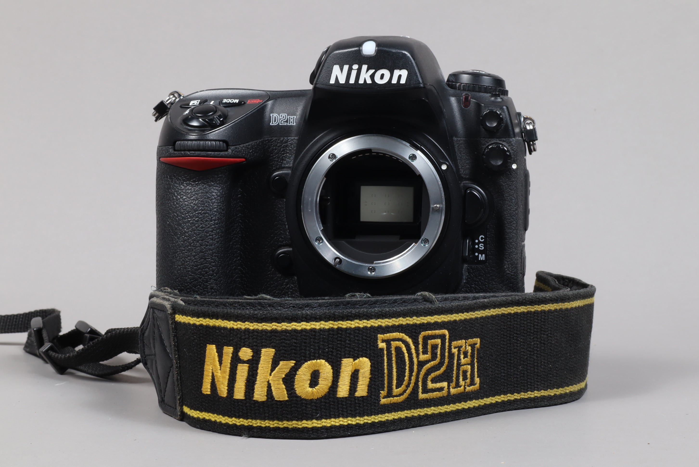 A Nikon D2H DSLR Camera body, serial no 2036416, body Gsome wear, light scratches to base, with body