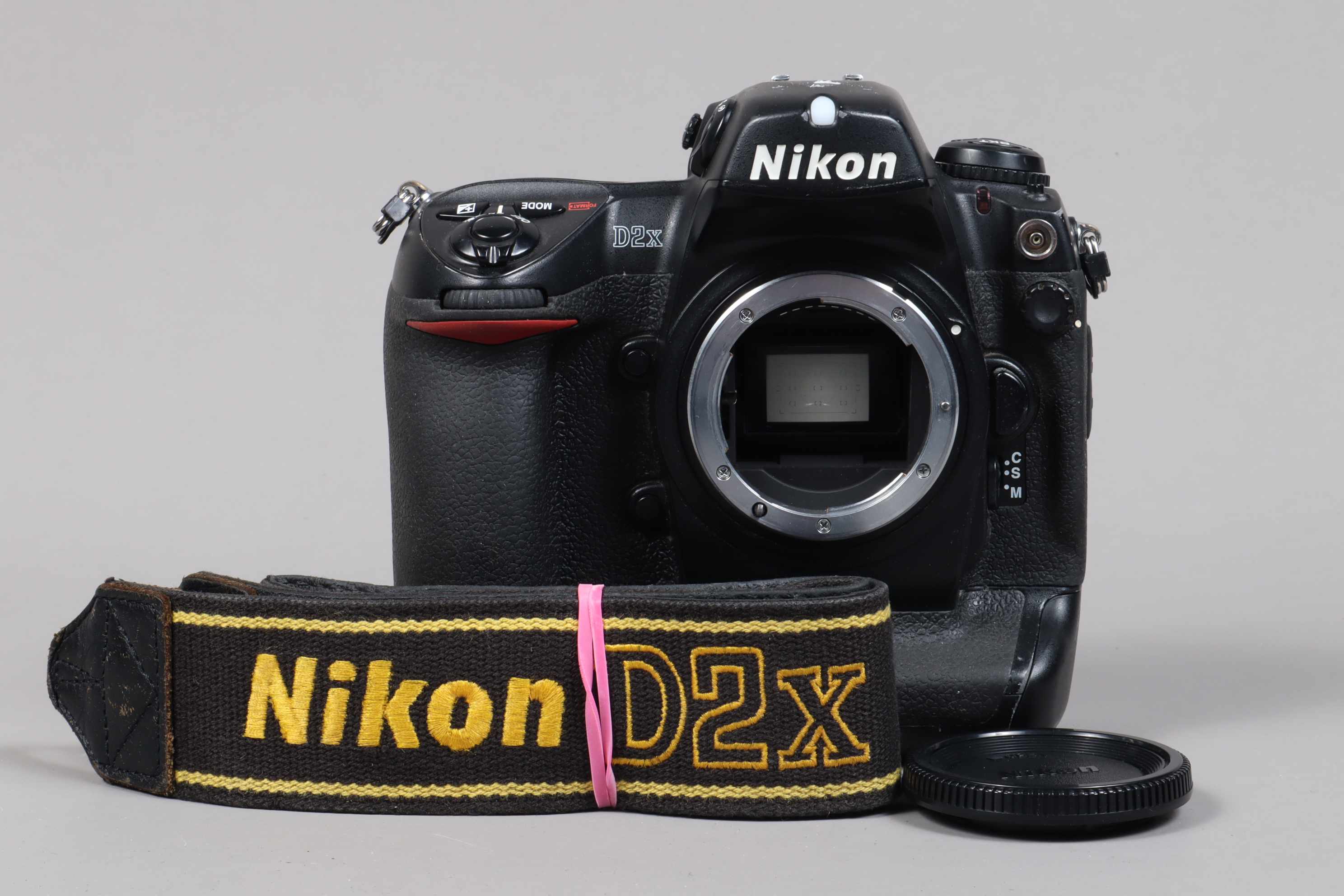 A Nikon D2x DSLR Camera Body, serial no 5047390, body G, some wear to edges, with body cap, strap,