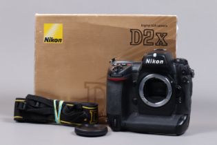 A Nikon D2x DSLR Camera Body, serial no 5051753, body G, light wear, with body cap, strap, quick