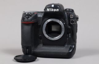 A Nikon D2H DSLR Camera body, serial no 2014874, body G, some wear, with unbranded body cap, battery