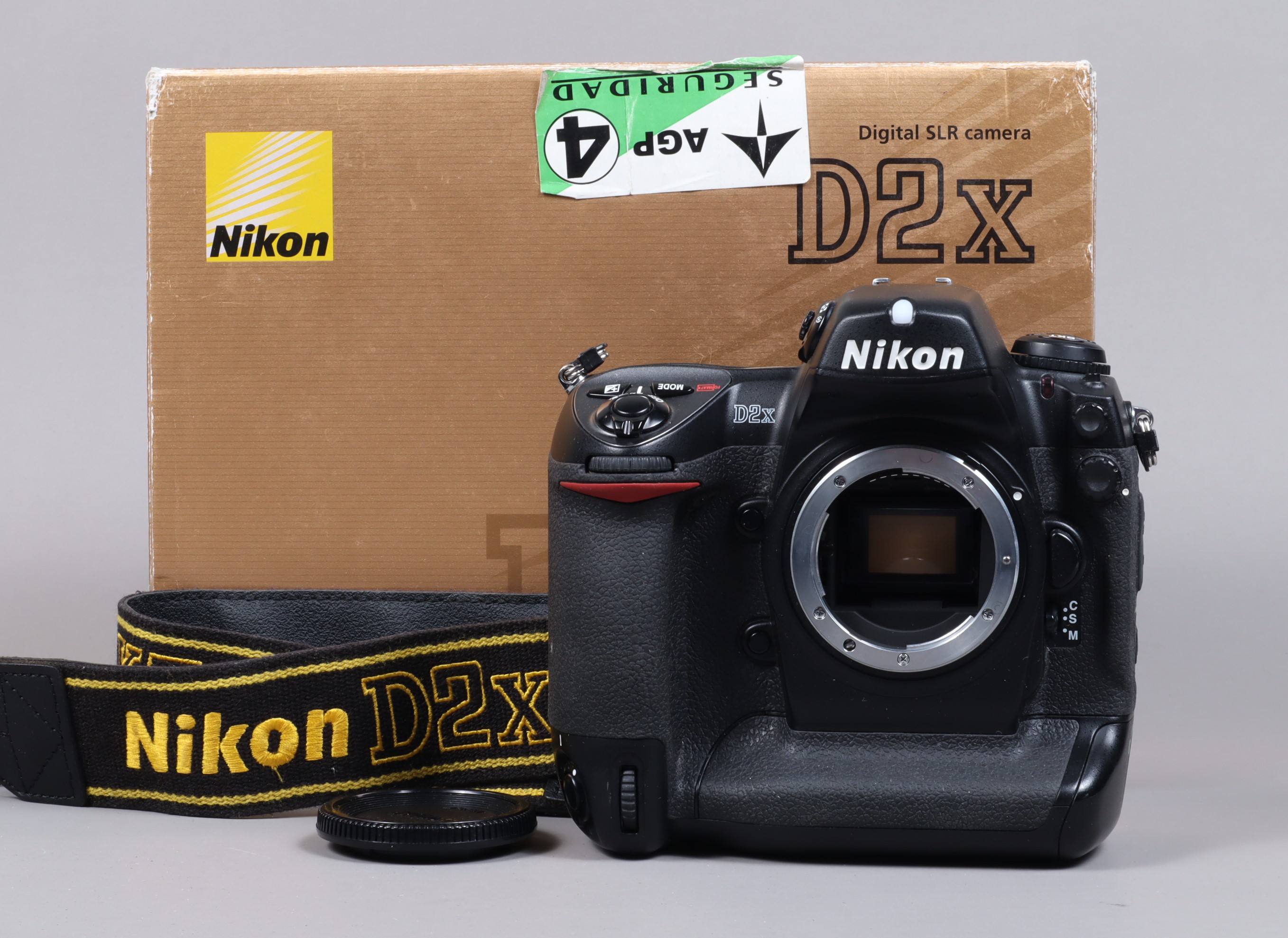 A Nikon D2x DSLR Camera Body, serial no 5043913, body G, light wear, with body cap, strap, manual,