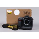 A Nikon D2x DSLR Camera Body, serial no 5075495, body G, some wear, missing leatherette from