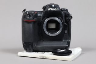 A Nikon D2H DSLR Camera body, serial no 2008285, body G, some wear, with body cap, manual, battery