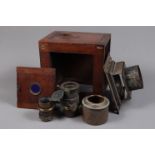 A Magic Lantern with Lenses, an incomplete wooden body magic lantern and two brass lenses with