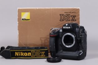 A Nikon D2x DSLR Camera Body, serial no 5046148, body G, some wear, with body cap, strap, battery,