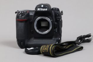 A Nikon D2H DSLR Camera body, serial no 2033910, body G, light wear, with body cap, strap, battery