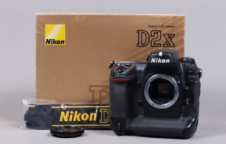 A Nikon D2x DSLR Camera Body, serial no 5067870, body G, light wear, with body cap, display screen