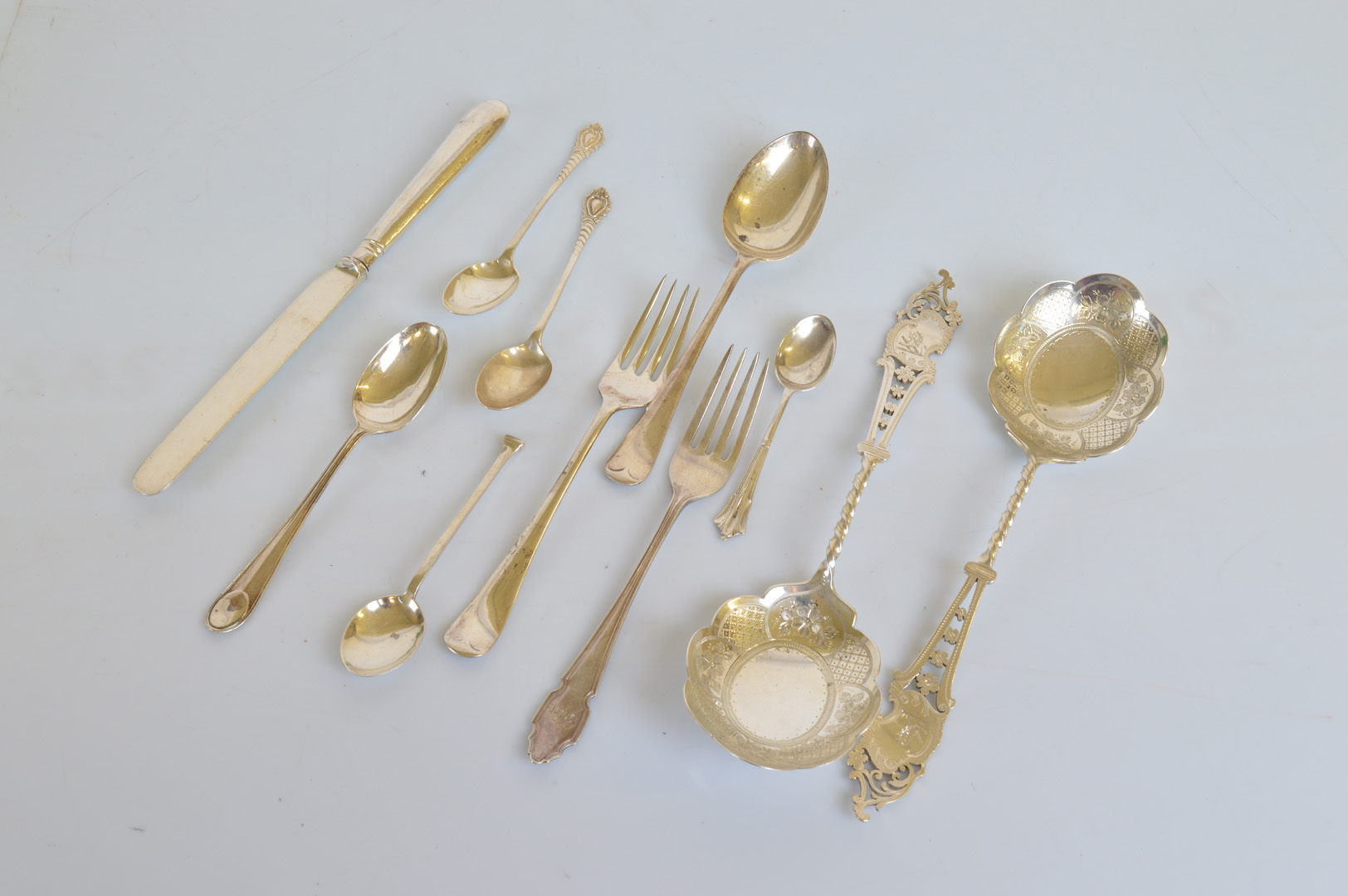 A pair of George V silver berry spoons, the shaped engraved bowls with barley twist stem and tapered