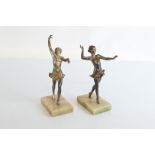 A pair of Art Deco spelter bronzed figurines, of dancing girls, in coloured dresses on rectangular