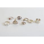 A collection of silver and white metal rings, including one with secret compartment, another set