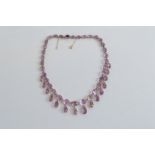 A late 19th or early 20th Century amethyst fringe necklace, on gold mounts, oval amethysts, claw