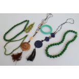 Two stained quartzite simulated spinach jade necklaces, two hardstone Chinese necklaces, and three