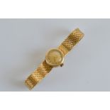 An 18ct gold lady's Omega wristwatch, with circular face, baton numerals, fine strap, Omega marked