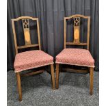 A pair of stained bedroom chairs, having string inlay and oval panel under pierced back support,