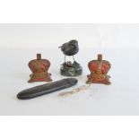 A pair of George VI cast iron money boxes, a Helen Dare bird sculpture and a pair of gold rimmed
