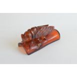 A carved amber bee, on a curved base, 10.5cm x 4.5cm x 5.5cm, 103g