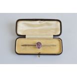 A yellow metal and platinum bar brooch, the oval mixed cut amethyst in claw setting, tipped platinum