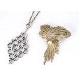 A 1970's silver modernist pendant and chain by Jack Spencer, of oval shape with looped decoration,