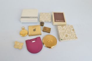 A collection of Stratton compacts, in the form of pocket fobs, squares, circles, various decorations