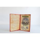 A certificated Spanish Carlos III silver Real, in carded folder, translated The Treasure of L