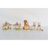 A pair of Staffordshire flatback figures, modelled as milkman and milkmaid with beasts, another