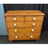 A 19th Century pine chest of drawers, having two short over three long drawers, on turned feet,