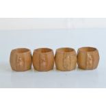 A set of four Robert Thompson Kilburn 'Mouseman' octagonal carved napkin rings, 5cm high x 6cm