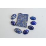 A quantity of loose lapis lazuli, including seven cabochons and a tablet