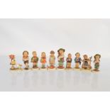 A collection of ten Hummel children figurines, including Home from Market, Doctor, Goose Girl,