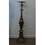 A late 19th/early 20th Century bronze torchere, in the Egyptian style, the circular top supported on